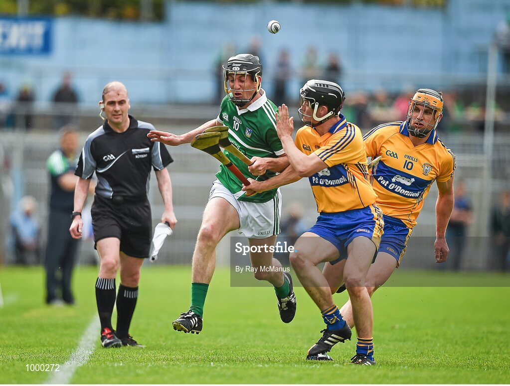 24 May 2015; Linesman Sean Cleere looks on as Clare's Jack Browne shoulders the Limerick captain Donal O'Grady. Munster GAA Hurling Senior Championship Quarter-Final, Clare v Limerick. Semple Stadium, Thurles, Co. Tipperary. Picture credit: Ray McManus / SPORTSFILE