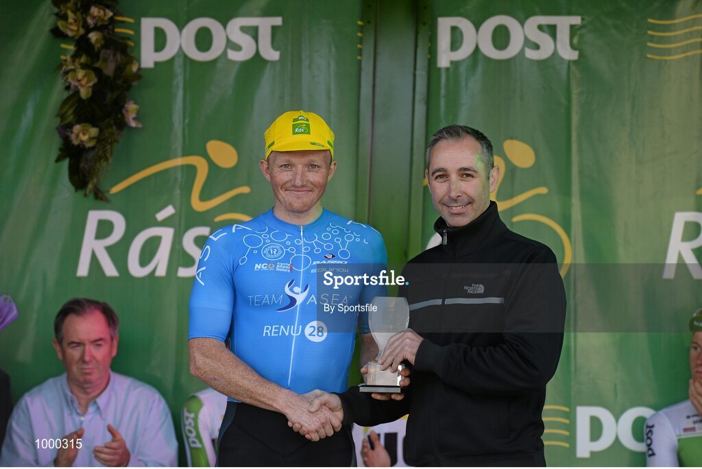 24 May 2015; Damien Shaw, Team Asea, after receiving the Cuchulainn statue for the first county rider home in Stage 8 from Stephen O'Sullivan following Stage 8 of the 2015 An Post Rás. Drogheda - Skerries. Photo by Sportsfile