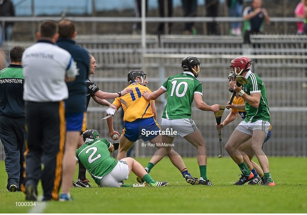 24 May 2015; Clare and Limerick players tussel with each other moments before half time. Referee Colm Lyons issued a red card to Patrick Donnellan shortly after and the Limerick captain Donal O'Grady, 10, was treated for an injury to the face. Munster GAA Hurling Senior Championship Quarter-Final, Clare v Limerick. Semple Stadium, Thurles, Co. Tipperary.  Picture credit: Ray McManus / SPORTSFILE