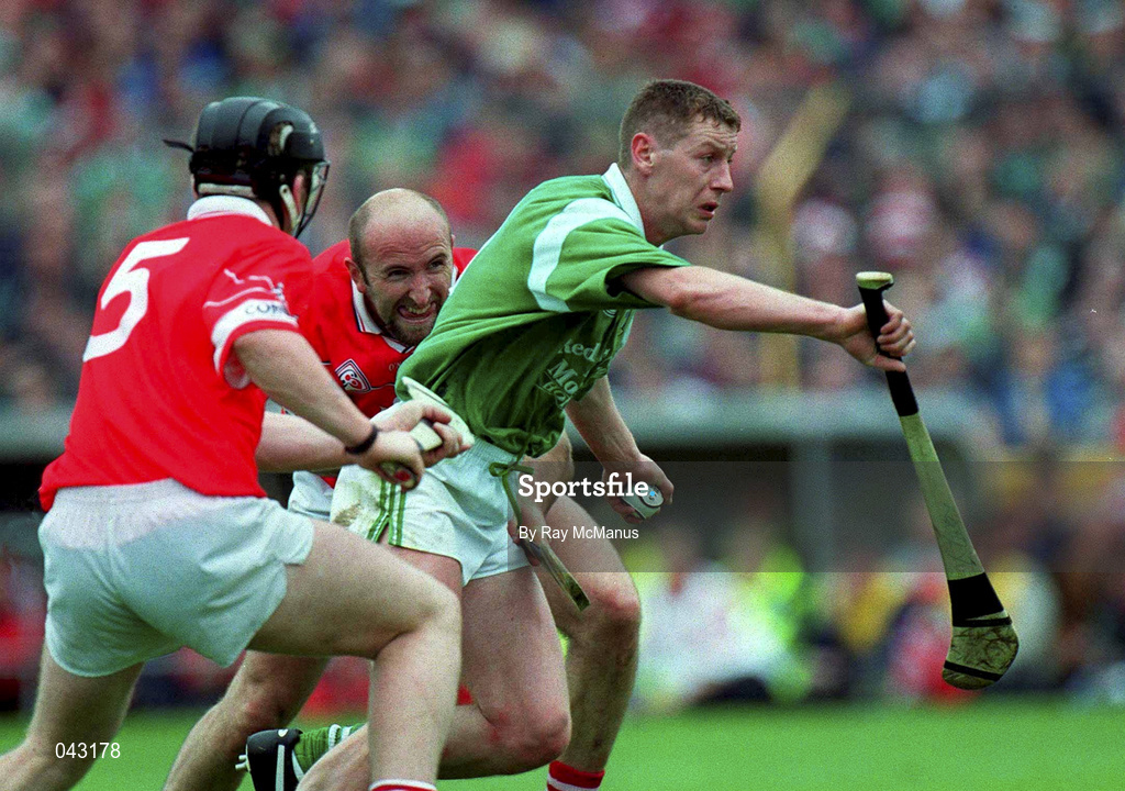 4 June 2000; Ciaran Carey of Limerick bursts past Cork defenders Wayne Sherlock, 5, and Brian Corcoran during the Guinness Munster Senior Hurling Championship Semi-Final match between Cork and Limerick at Semple Stadium in Thurles, Tipperary. Photo by Ray McManus/Sportsfile