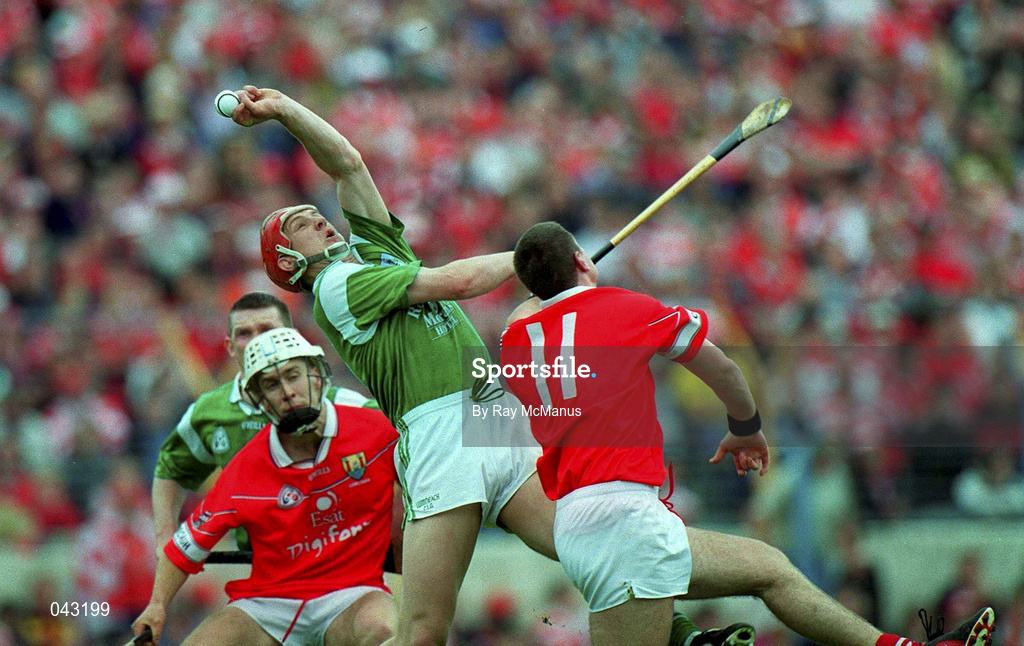4 June 2000; Ollie Moran of Limerick gains possession under pressure from Fergal McCormack of Cork, 11, during the Guinness Munster Senior Hurling Championship Semi-Final match between Cork and Limerick at Semple Stadium in Thurles, Tipperary. Photo by Ray McManus/Sportsfile