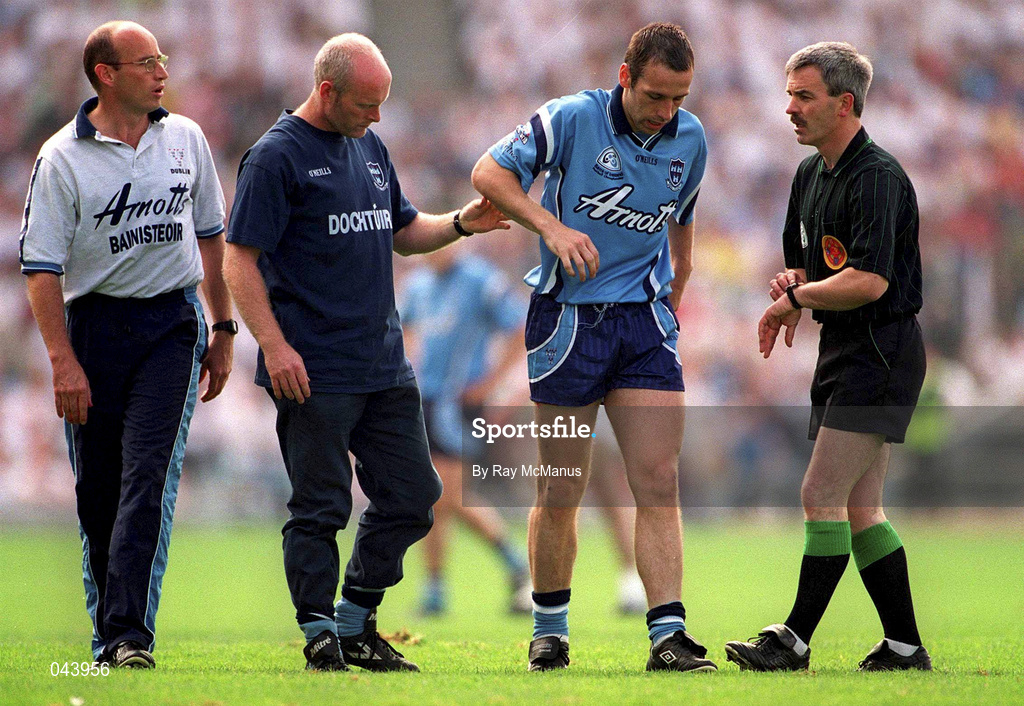 30 July 2000; Dublin's Ian Robertson is helped off the field by Dr Noel McCaffrey, Dublin team doctor, also pictured are Tommy Carr, Dublin manager, left, and referee Paddy Russell during the Bank of Ireland Leinster Senior Football Championship Final between Dublin and Kildare at Croke Park in Dublin. Photo by Ray McManus/Sportsfile
