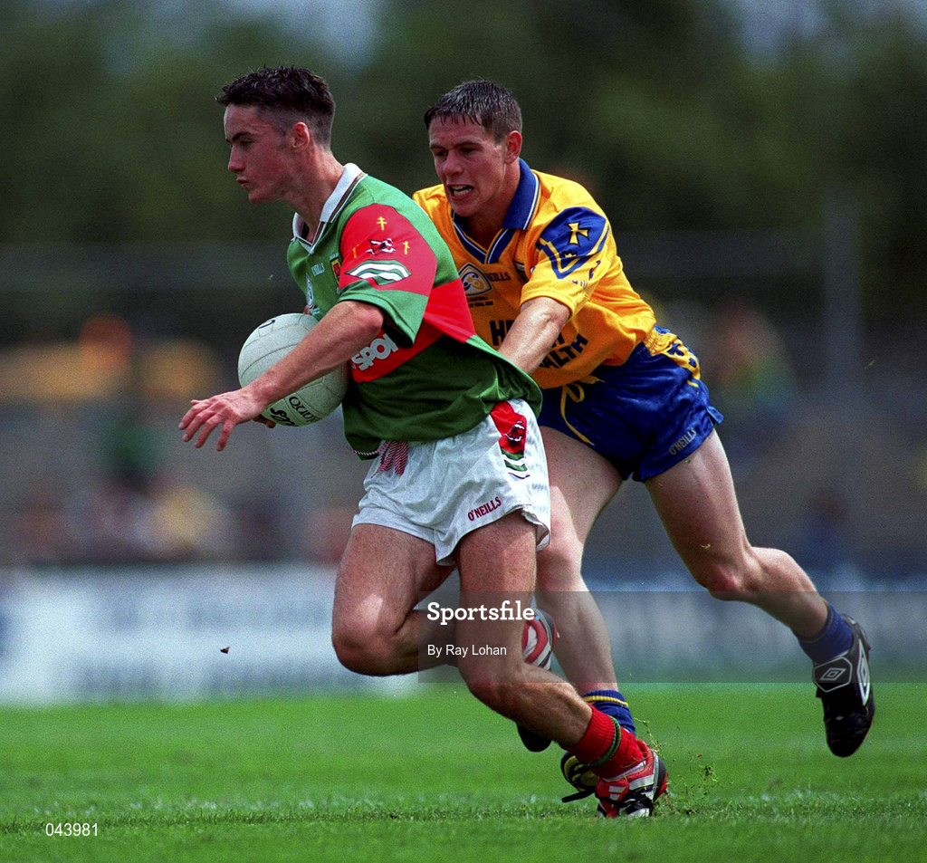 30 July 2000; Conor Moran of Mayo is tackled by Paul Tiernan of Roscommon during the Connacht Minor Football Championship Final between Roscommon and Mayo at Dr Hyde Park in Roscommon. Photo by Ray Lohan/Sportsfile