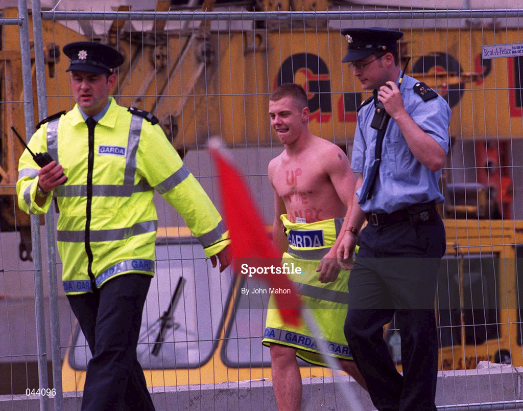 30 July 2000; A streaker, Brian Togher, is escorted from the stadium by members of An Garda Síochána during the Bank of Ireland Leinster Senior Football Championship Final between Dublin and Kildare at Croke Park in Dublin. Photo by John Mahon/Sportsfile