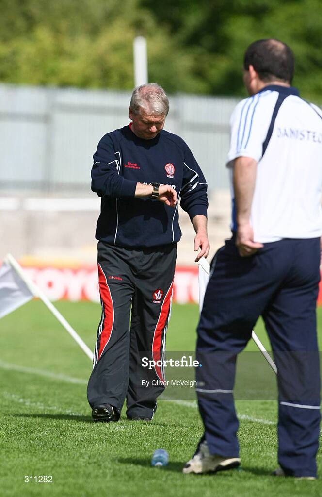 19 July 2008; Derry manager Paddy Crozier checks his watch as Monaghan manager Seamus McEnaney looks on. GAA Football All-Ireland Senior Championship Qualifier - Round 1, Monaghan v Derry, Clones, Co. Monaghan. Picture credit: Oliver McVeigh / SPORTSFILE