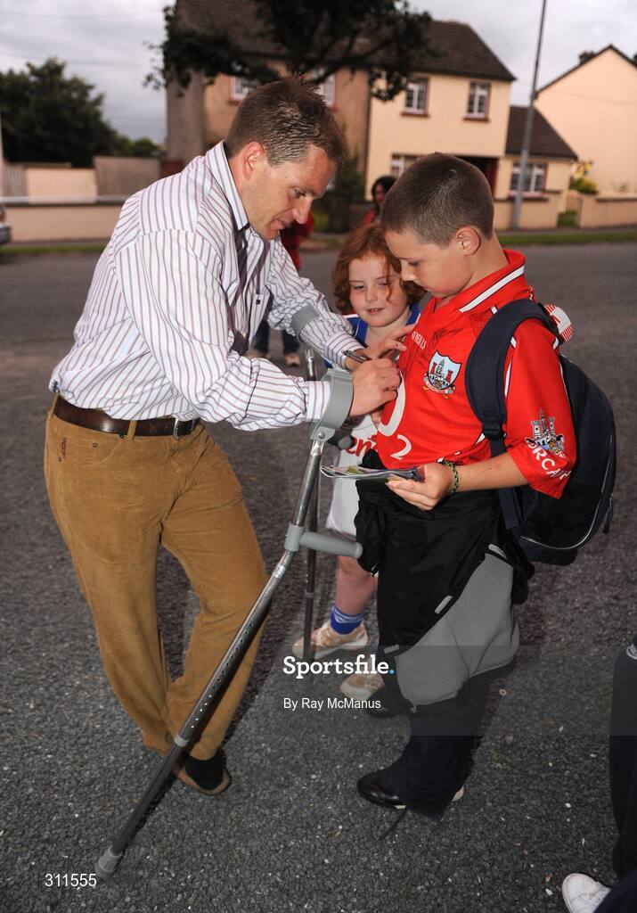 19 July 2008; Cork's Joe Deane signs an autograph after the match for Cork supporter Patrick Ryan, from Nurney, Co. Kildare. GAA Hurling All-Ireland Senior Championship Qualifier - Round 4, Cork v Galway, Thurles, Co. Tipperary. Picture credit: Ray McManus / SPORTSFILE