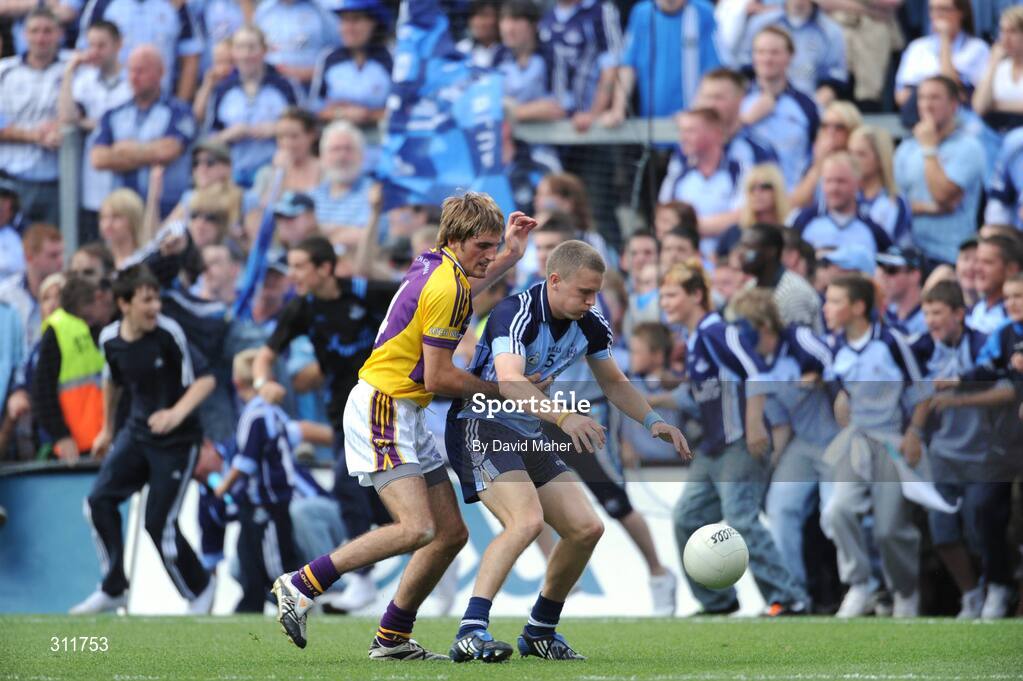 20 July 2008; Tomas Quinn, Dublin, in action against Brian Malone, Wexford, as supporters invade the pitch during the closing stages of the match. GAA Football Leinster Senior Championship Final, Dublin v Wexford, Croke Park, Dublin. Picture credit: David Maher / SPORTSFILE