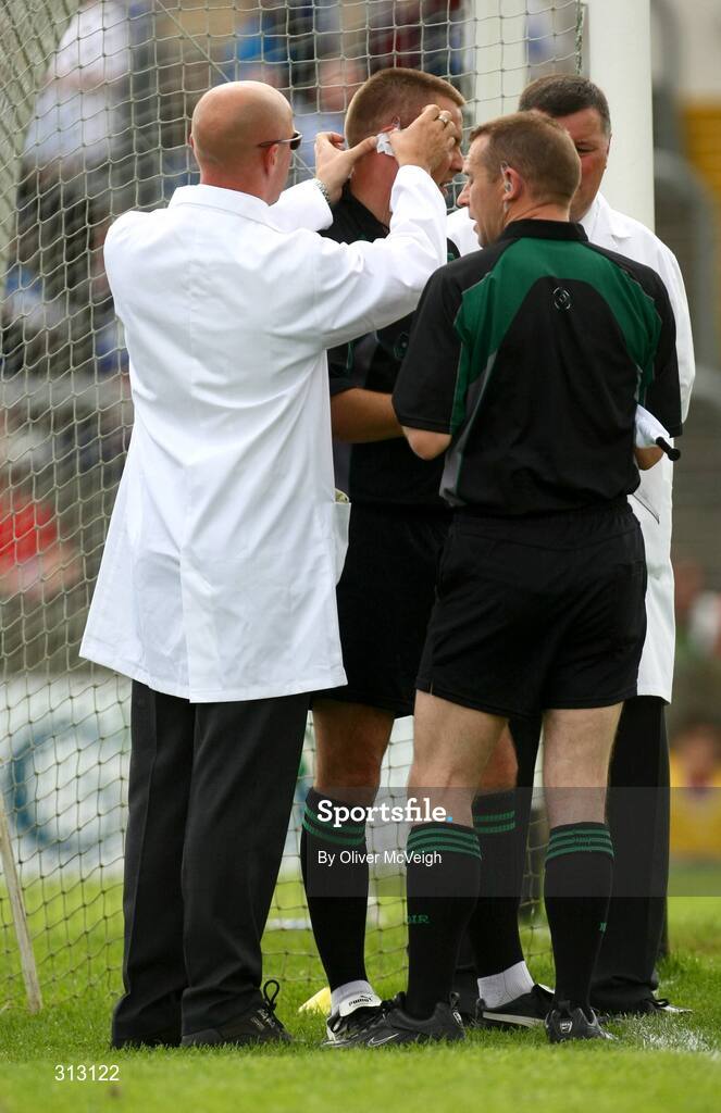 24 July 2008; Referee Rory Hickey has his ear pieced fixed by one of his umpires during the first half. GAA Football All-Ireland Senior Championship Qualifier - Round 2, Donegal v Monaghan, Ballybofey, Co. Donegal. Picture credit: Oliver McVeigh / SPORTSFILE