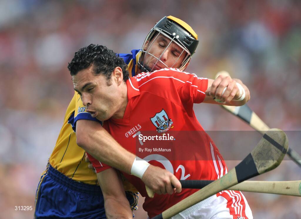 27 July 2008; Cork's Sean Og O hAilpin clears under pressure from Clare's Tony Griffin. GAA Hurling All-Ireland Senior Championship Quarter-Final, Clare v Cork, Semple Stadium, Thurles, Co. Tipperary. Picture credit: Ray McManus / SPORTSFILE