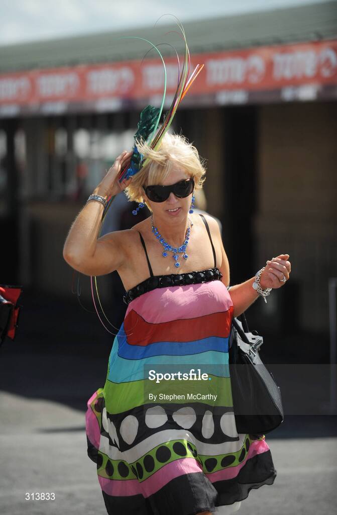 30 July 2008; Orlagh Winters, from Loughrea, Co. Galway, holds onto her hat during the third day of the Galway Racing Festival. Galway Racing Festival - Wednesday, Ballybrit, Galway. Picture credit: Stephen McCarthy / SPORTSFILE