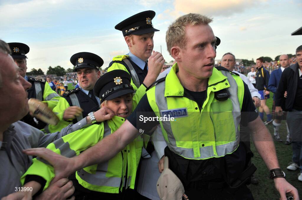 30 July 2008; An umpire, hidden, is escorted by Gardai after the game. Bord Gais Munster GAA Hurling U21 Championship Final, Clare v Tipperary, Cusack Park, Ennis, Co. Clare. Picture credit: Matt Browne / SPORTSFILE