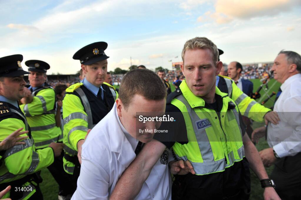 30 July 2008; An umpire is escorted by Gardai after the game. Bord Gais Munster GAA Hurling U21 Championship Final, Clare v Tipperary, Cusack Park, Ennis, Co. Clare. Picture credit: Matt Browne / SPORTSFILE