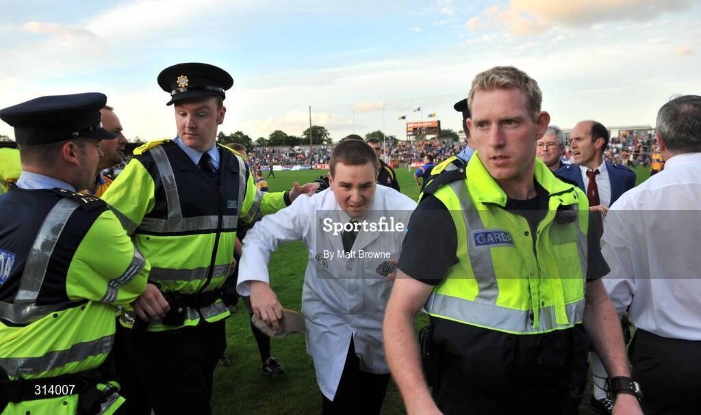 30 July 2008; An umpire is escorted by Gardai after the game. Bord Gais Munster GAA Hurling U21 Championship Final, Clare v Tipperary, Cusack Park, Ennis, Co. Clare. Picture credit: Matt Browne / SPORTSFILE