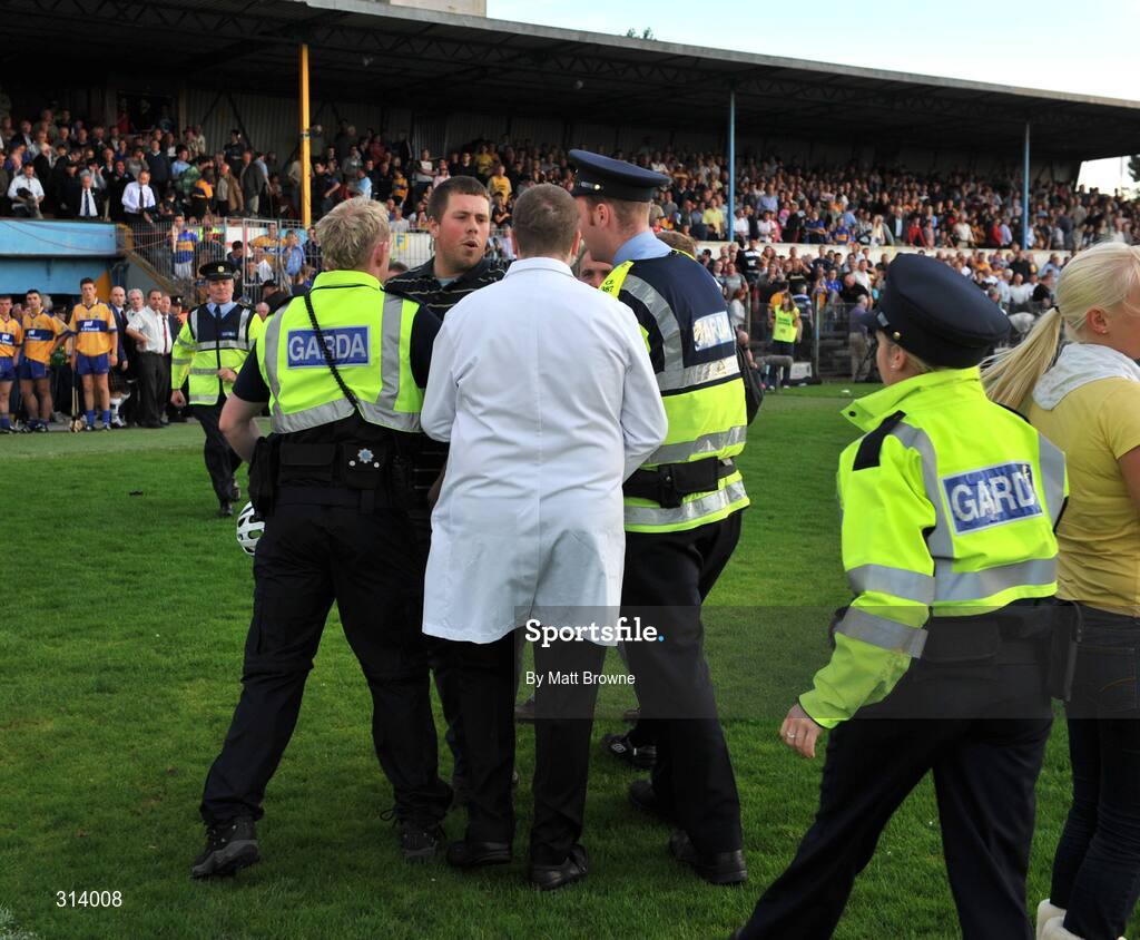 30 July 2008; An umpire is escorted by Gardai after the game. Bord Gais Munster GAA Hurling U21 Championship Final, Clare v Tipperary, Cusack Park, Ennis, Co. Clare. Picture credit: Matt Browne / SPORTSFILE