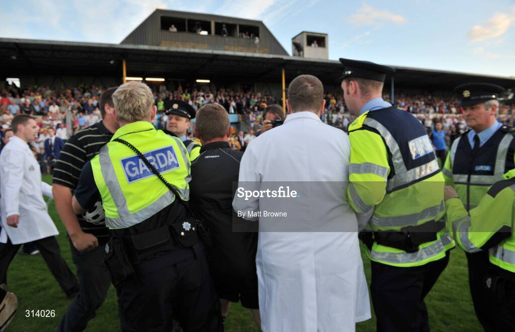 30 July 2008; An umpire is escorted by Gardai after the game. Bord Gais Munster GAA Hurling U21 Championship Final, Clare v Tipperary, Cusack Park, Ennis, Co. Clare. Picture credit: Matt Browne / SPORTSFILE