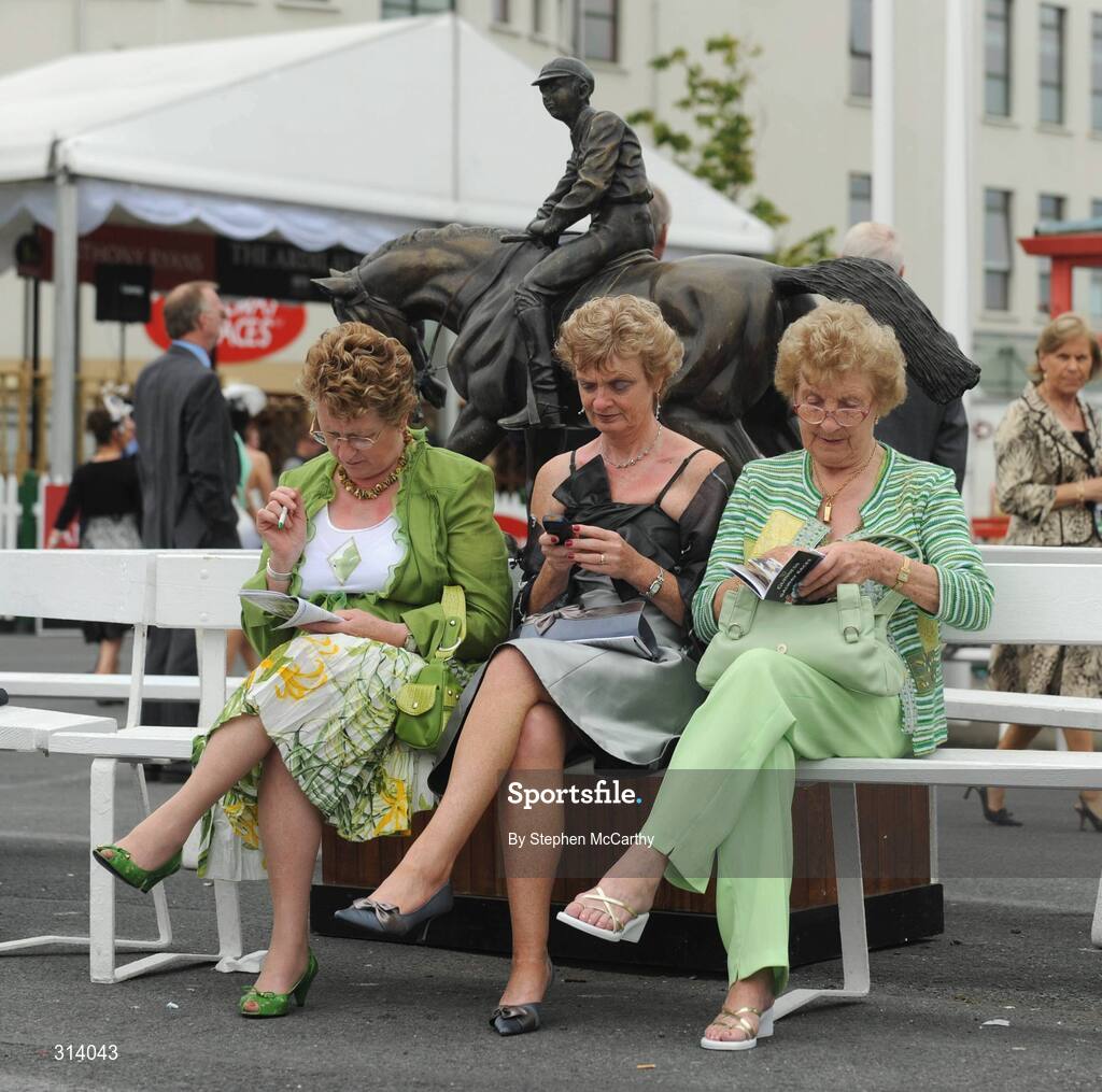 31 July 2008; Racegoers examine the form during the fourth day of the Galway Racing Festival. Galway Racing Festival, Ballybrit, Co. Galway. Picture credit: Stephen McCarthy / SPORTSFILE
