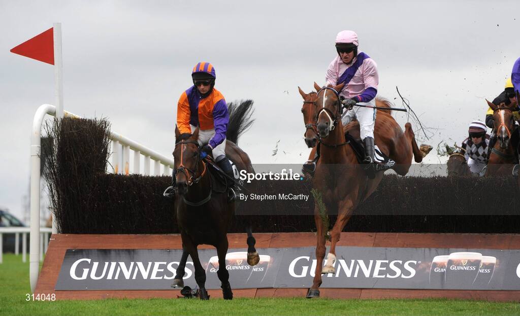 31 July 2008; Eventual winner Tasman, with Barry Geraghty up, right, jumps alongside Rory's Sister, with Denis Hogan up, during the Guinness Beginners Chase. Galway Racing Festival, Ballybrit, Co. Galway. Picture credit: Stephen McCarthy / SPORTSFILE