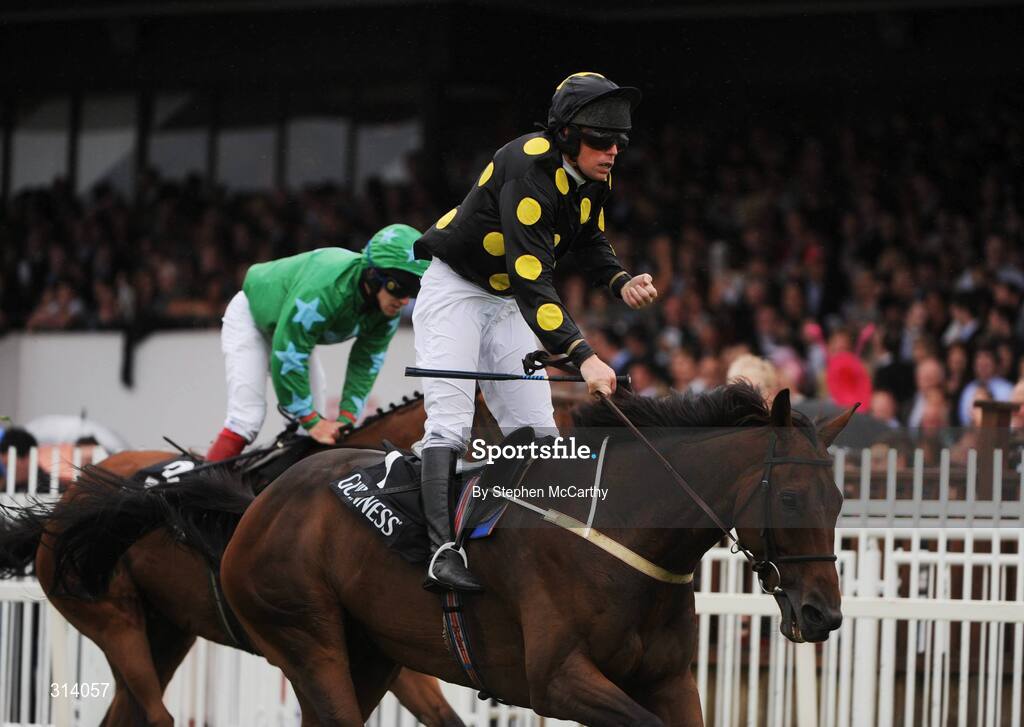 31 July 2008; Jockey Barry Cash celebrates after winning the Guinness Novice Chase onboard Skip Two from second place Dreamy Gent, with Andrew Leigh up. Galway Racing Festival - Thursday, Ballybrit, Co. Galway. Picture credit: Stephen McCarthy / SPORTSFILE