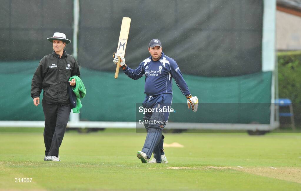 31 July 2008; Scotland captain Ryan Watson celebrates his 50 against Ireland as test match umpire Billy Bowden from New Zealand looks on during the match. Ireland v Scotland, One Day International, Clontarf Cricket Club, Dublin. Picture credit: Matt Browne / SPORTSFILE