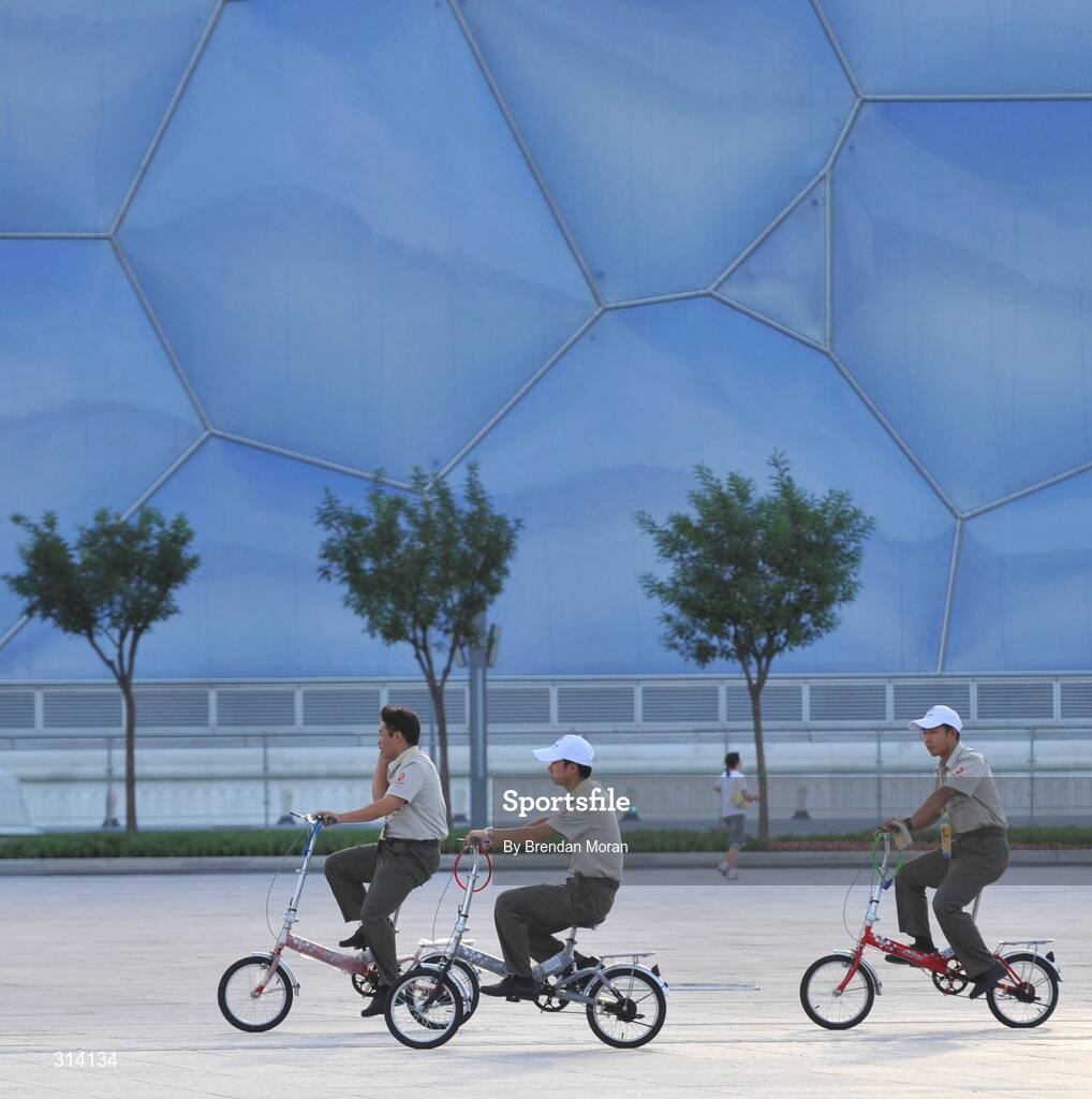1 August 2008; Security workers on their way home cycle past the National Aquatic Centre, also known as the water cube, as preparations continue ahead of the opening ceremony on Friday next, 8th of August. Beijing 2008 - Games of the XXIX Olympiad, National Stadium, Olympic Green, Beijing, China. Picture credit: Brendan Moran / SPORTSFILE