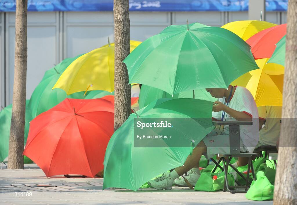 2 August 2008; A performer shields himself while waiting in the sun before rehearsals for the Opening Ceremony on Friday the 8th. Preparations continue ahead of the Games which start on Saturday the 9th of August. Beijing 2008 - Games of the XXIX Olympiad, Olympic Green, Beijing, China. Picture credit: Brendan Moran / SPORTSFILE