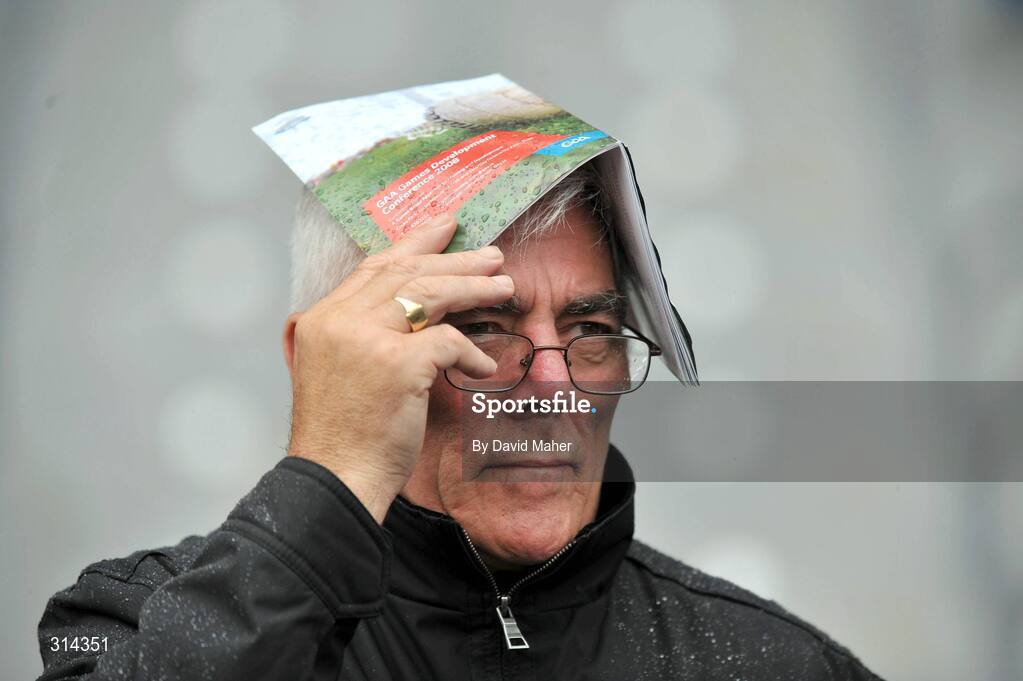 3 August 2008; A spectator takes cover from the rain with his programme during the Kildare v Fermanagh game. All-Ireland Senior Football Championship Qualifier, Round 3, Fermanagh v Kildare, Croke Park, Dublin. Picture credit: David Maher / SPORTSFILE