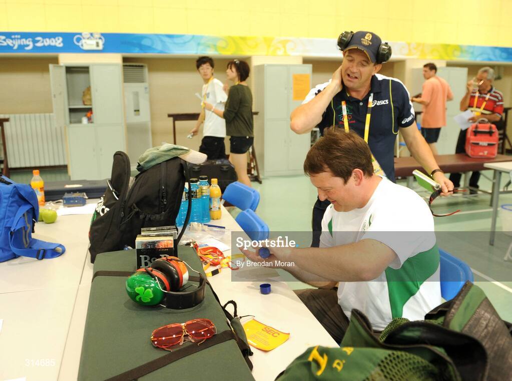 6 August 2008; Ireland's Derek Burnett and sports psychologist Peter Terry put on some mosquito repellent before heading out for a training session. Beijing 2008 - Games of the XXIX Olympiad, Beijing Shooting Range, Xiangshan nan Road, Haidian District, Beijing, China. Picture credit: Brendan Moran / SPORTSFILE