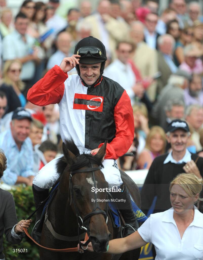 30 July 2008; A delighted Ruby Walsh tips his cap as he enters the winners enclosure after winning the William Hill Galway Plate onboard Oslot. Galway Racing Festival - Wednesday, Ballybrit, Galway. Picture credit: Stephen McCarthy / SPORTSFILE