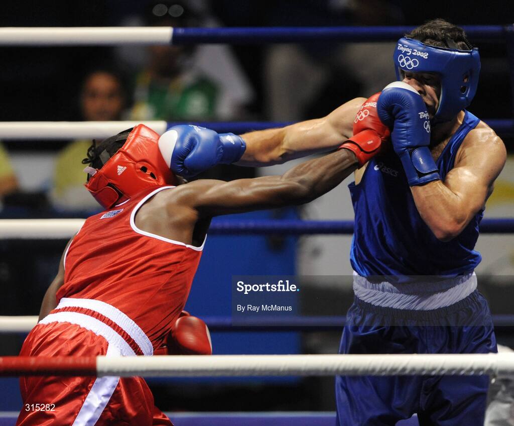 9 August 2008; Julius Jackson, red, Virgin Islands, lands a straight right on Ireland's Ken Egan during their first round contest in the Light heavy weight, 81 kg, class. Beijing 2008 - Games of the XXIX Olympiad, Beijing Workers Gymnasium, Olympic Green, Beijing, China. Picture credit: Ray McManus / SPORTSFILE