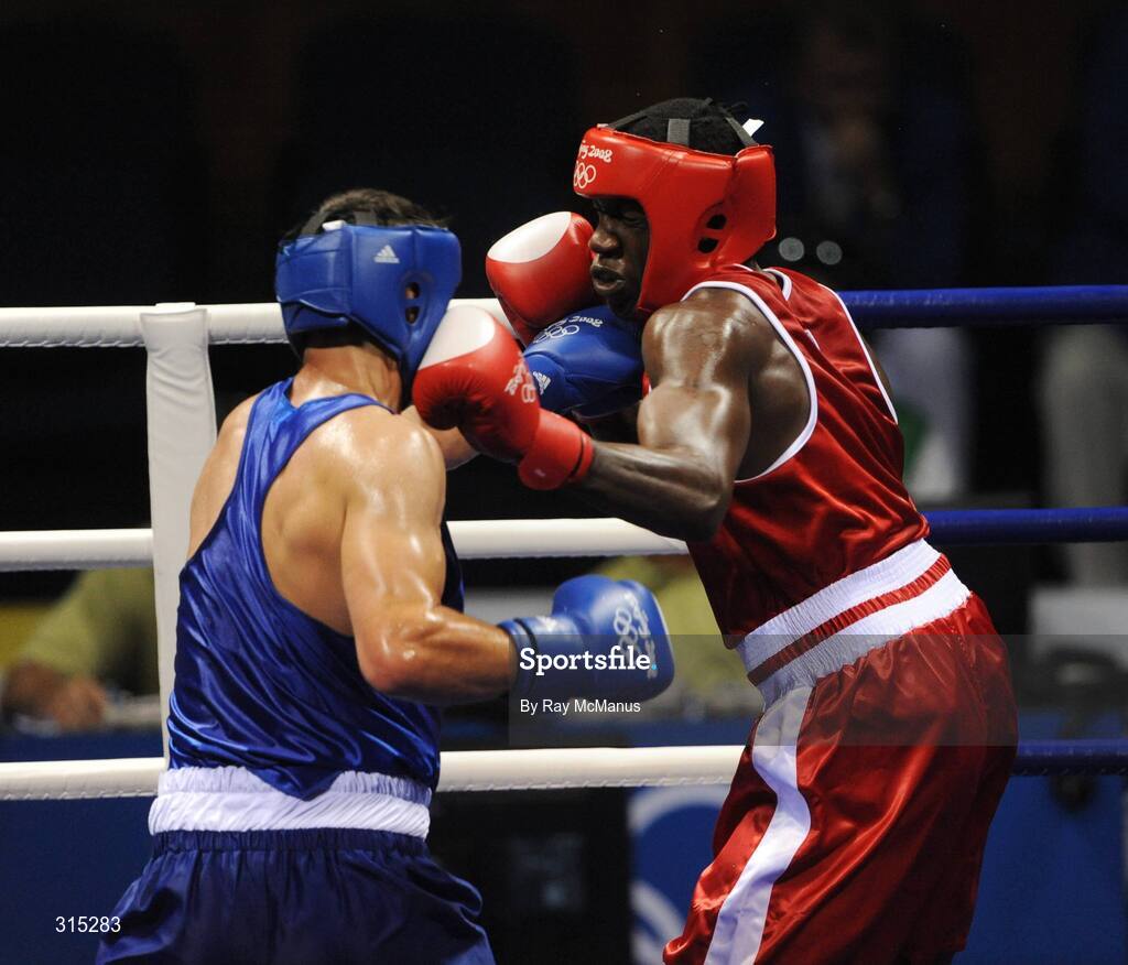 9 August 2008; Ken Egan, Ireland, in action against Julius Jackson, red, Virgin Islands, during the first round of the Light heavy weight, 81 kg, contest. Beijing 2008 - Games of the XXIX Olympiad, Beijing Workers Gymnasium, Olympic Green, Beijing, China. Picture credit: Ray McManus / SPORTSFILE