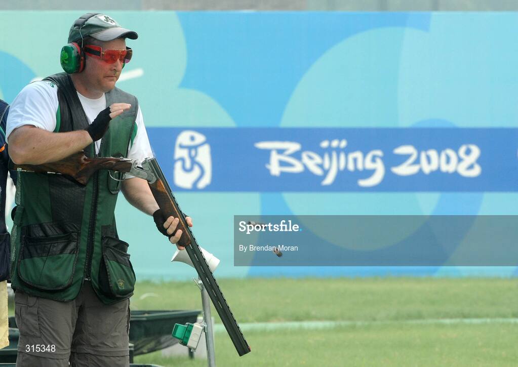 9 August 2008; Ireland's Derek Burnett disposes of his spent cartridges during Men's Trap Qualification. Beijing 2008 - Games of the XXIX Olympiad, Beijing Shooting Range, Xiangshan nan Road, Haidian District, Beijing, China. Picture credit: Brendan Moran / SPORTSFILE