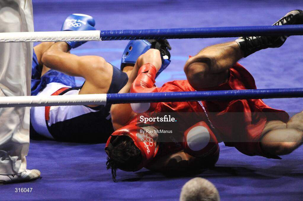 14 August 2008; Both Kenny Egan, Ireland, and Bahram Muzaffer, Turkey, in the blue vest, fall to the canvas during the 'round of 16' Light heavy weight, 81 kg, contest. Beijing 2008 - Games of the XXIX Olympiad, Beijing Workers Gymnasium, Olympic Green, Beijing, China. Picture credit: Ray McManus / SPORTSFILE