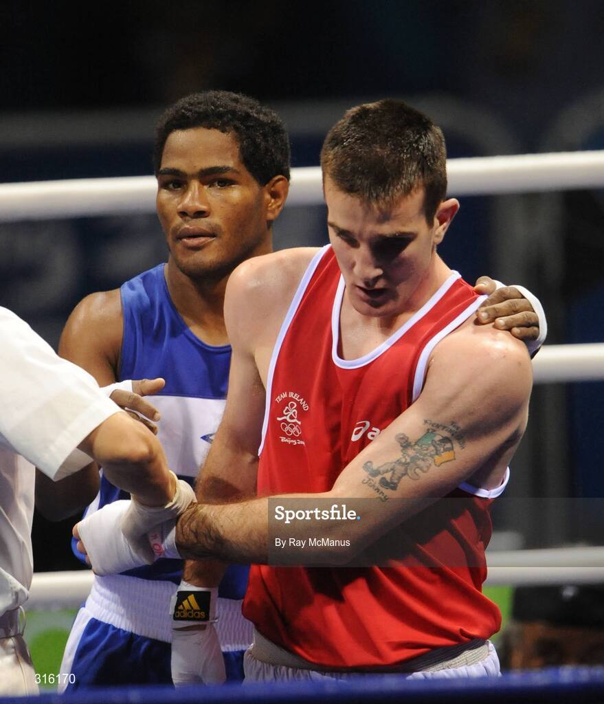 14 August 2008; Ireland's John Joe Joyce shows his disappointment as Felix Diaz, of the Dominican Republic, celebrates victory in the 'round of 16' Light welter weight, 64 kg, contest. Beijing 2008 - Games of the XXIX Olympiad, Beijing Workers Gymnasium, Olympic Green, Beijing, China. Picture credit: Ray McManus / SPORTSFILE