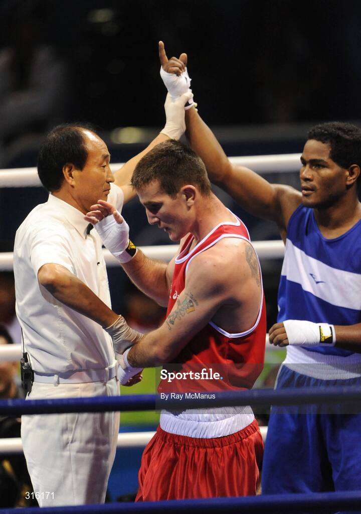 14 August 2008; Ireland's John Joe Joyce shows his disappointment as Felix Diaz, of the Dominican Republic, celebrates victory in the 'round of 16' Light welter weight, 64 kg, contest. Beijing 2008 - Games of the XXIX Olympiad, Beijing Workers Gymnasium, Olympic Green, Beijing, China. Picture credit: Ray McManus / SPORTSFILE
