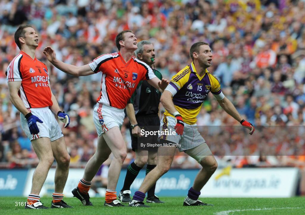 9 August 2008; Matty Forde, Wexford, watches his kick go over the bar alongside Paul McGrane, left, and Kieran Toner, Armagh, and referee Paddy Russell, Tipperary. GAA Football All-Ireland Senior Championship Quarter-Final, Armagh v Wexford, Croke Park, Dublin. Picture credit: Stephen McCarthy / SPORTSFILE