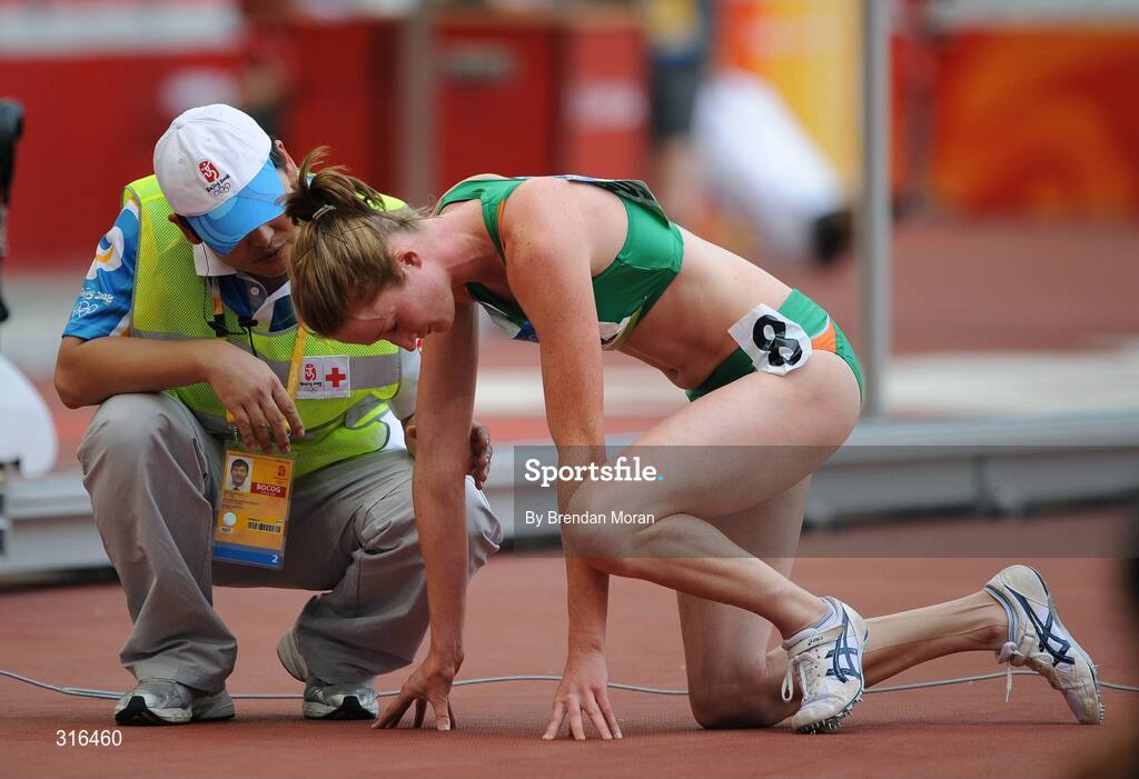 16 August 2008; Joanne Cuddihy, Ireland, is given assistance by medical personnel after her heat of the Women's 400m, in which she finished 6th in a time of 53.32. Beijing 2008 - Games of the XXIX Olympiad, National Stadium, Olympic Green, Beijing, China. Picture credit: Brendan Moran / SPORTSFILE