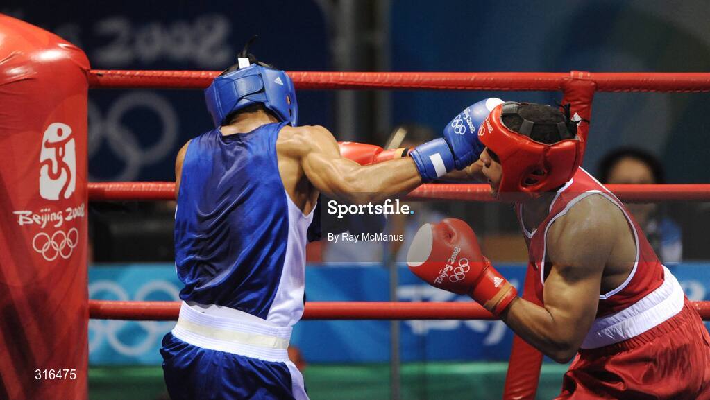 16 August 2008; Darren Sutherland, Ireland, in action against Nabil Kassel, from Algeria, during the 'round of 16' Middle weight, 75kg, contest. Beijing 2008 - Games of the XXIX Olympiad, Beijing Workers Gymnasium, Olympic Green, Beijing, China. Picture credit: Ray McManus / SPORTSFILE