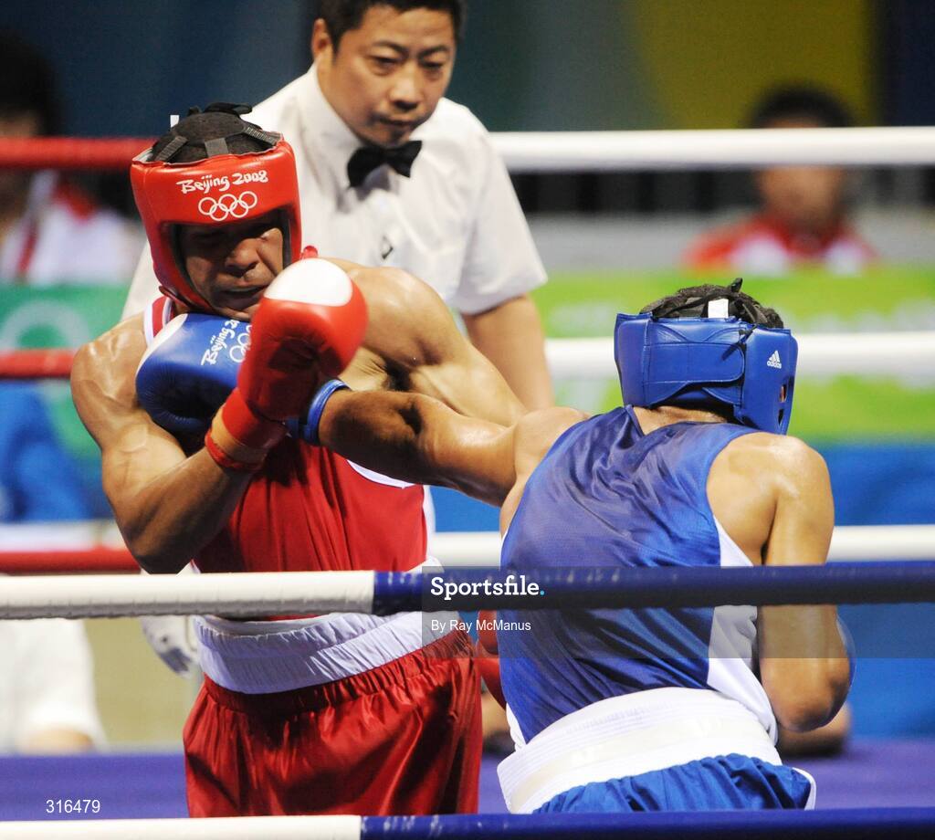 16 August 2008; Darren Sutherland, Ireland, in action against Nabil Kassel, from Algeria, during the 'round of 16' Middle weight, 75kg, contest. Beijing 2008 - Games of the XXIX Olympiad, Beijing Workers Gymnasium, Olympic Green, Beijing, China. Picture credit: Ray McManus / SPORTSFILE