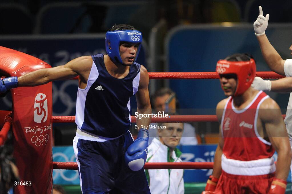 16 August 2008; Ireland's Darren Sutherland heads for a neutral corner as the referee gives Nabil Kassel, from Algeria, a standing count in the 'round of 16' Middle weight, 75kg, contest. Beijing 2008 - Games of the XXIX Olympiad, Beijing Workers Gymnasium, Olympic Green, Beijing, China. Picture credit: Ray McManus / SPORTSFILE