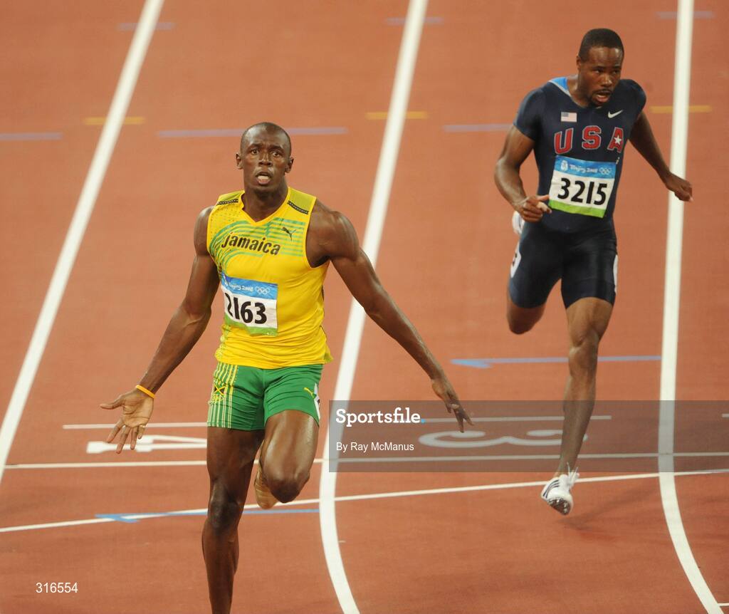 16 August 2008; Usain Bolt, of Jamaica, 2163, crosses the line clear of Darvis Patton, USA, and the field, to win the Men's 100m Final in a world record time of 9.69 seconds. Beijing 2008 - Games of the XXIX Olympiad, National Stadium, Olympic Green, Beijing, China. Picture credit: Ray McManus / SPORTSFILE