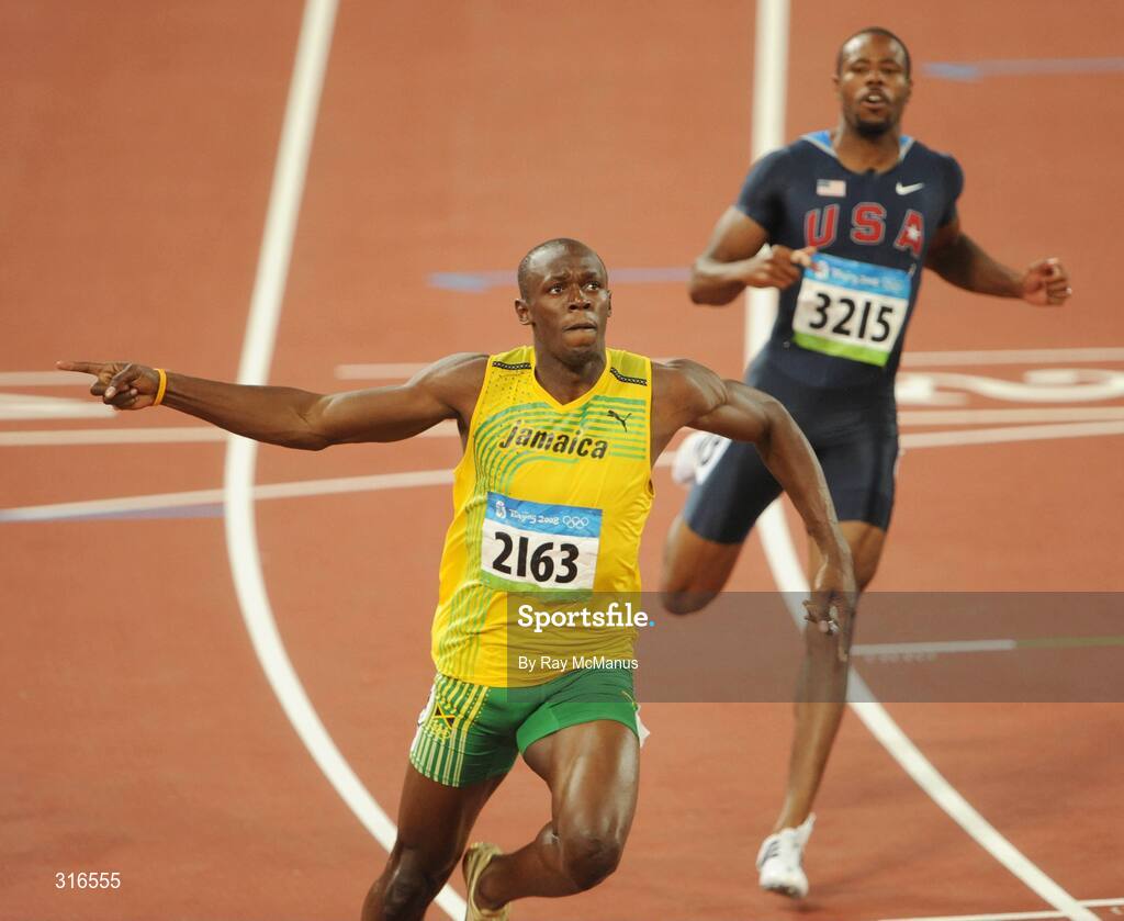 16 August 2008; Usain Bolt, of Jamaica, 2163, crosses the line clear of Darvis Patton, USA, and the field, to win the Men's 100m Final in a world record time of 9.69 seconds. Beijing 2008 - Games of the XXIX Olympiad, National Stadium, Olympic Green, Beijing, China. Picture credit: Ray McManus / SPORTSFILE