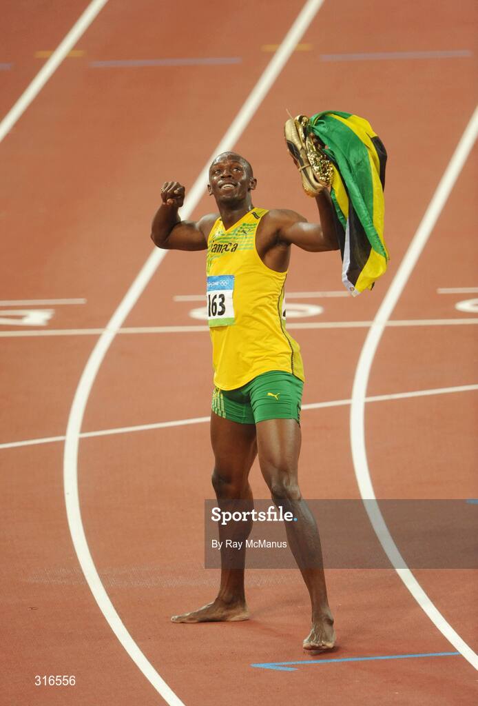 16 August 2008; Usain Bolt, of Jamaica, celebrates with a lap of honour after winning the Men's 100m Final in a world record time of 9.69 seconds. Beijing 2008 - Games of the XXIX Olympiad, National Stadium, Olympic Green, Beijing, China. Picture credit: Ray McManus / SPORTSFILE