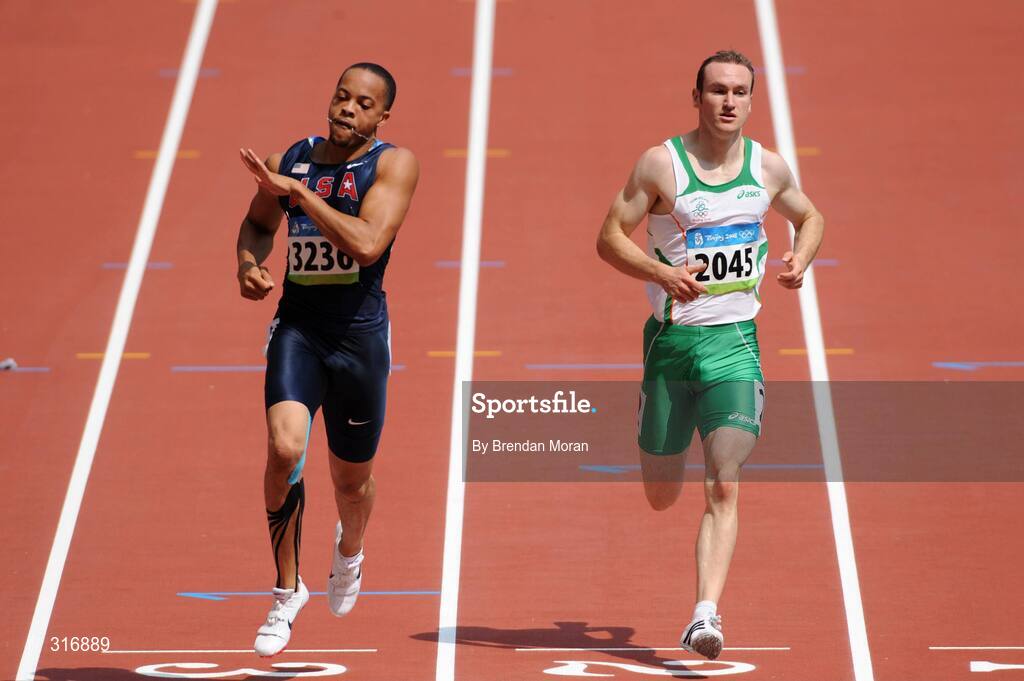 18 August 2008; Paul Hession, 2045, Ireland, finishes alongside Wallace Spearmon, 3236, of the USA, during the Round 1 heats of the Men's 400m heats, where he finished 3rd in a time of 20.59 and progressed to Round 2. Beijing 2008 - Games of the XXIX Olympiad, National Stadium, Olympic Green, Beijing, China. Picture credit: Brendan Moran / SPORTSFILE