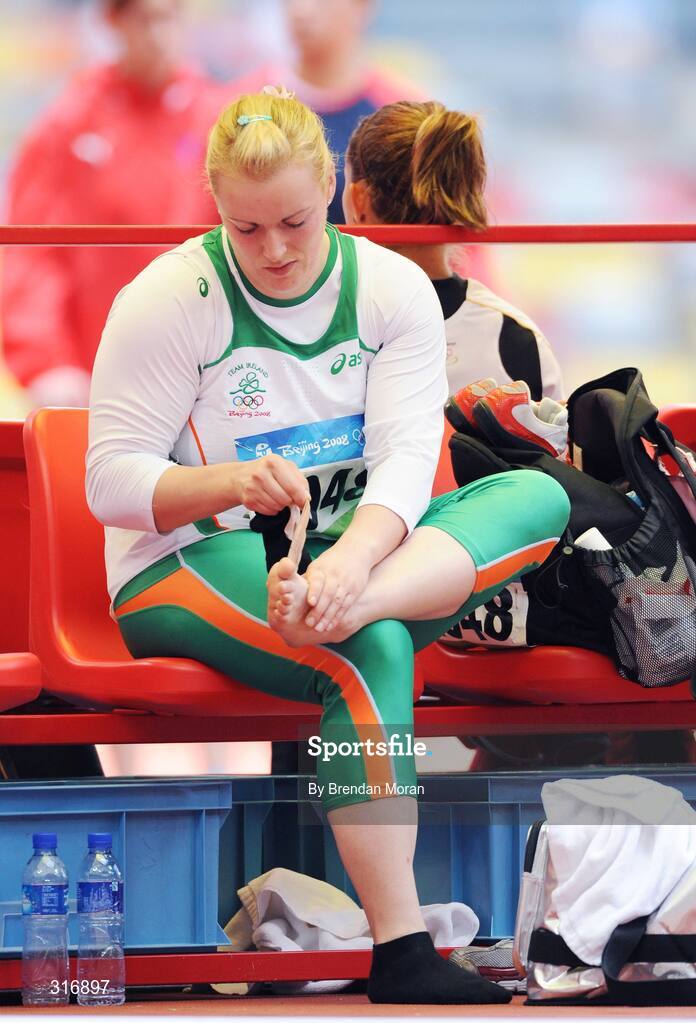 18 August 2008; Eileen O'Keeffe, Ireland, removes a bandage from her foot after Group B qualifying in the Women's Hammer. She threw a best of 67.66m but failed to qualify for the final. Beijing 2008 - Games of the XXIX Olympiad, National Stadium, Olympic Green, Beijing, China. Picture credit: Brendan Moran / SPORTSFILE