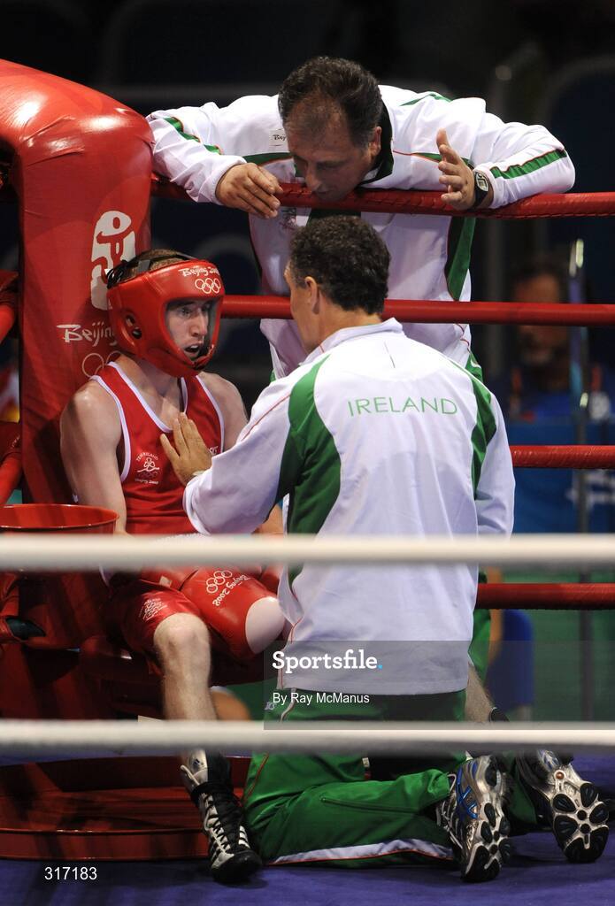 19 August 2008; Paddy Barnes, Ireland, listens to advise from head coach Billy Walsh, kneeling, and technical coach Zaur Antia between rounds during his bout with Lukasz Maszczyk, from Poland, in a quarter-final bout of the Light Fly weight, 48kg, contest. Beijing 2008 - Games of the XXIX Olympiad, Beijing Workers Gymnasium, Olympic Green, Beijing, China. Picture credit: Ray McManus / SPORTSFILE