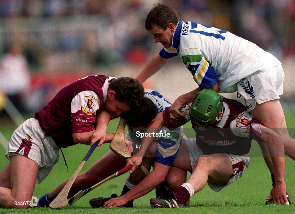 30 April 2000; Paul Hardiman, Galway, left and teammate Vennie Maher, Galway, green helmet tackle Anthony Kirwan, Waterford supported by teammate Michael White. Galway v Waterford, National Hurling League Semi-final, Semple Stadium, Thurles. Picture credit; Ray McManus/SPORTSFILE