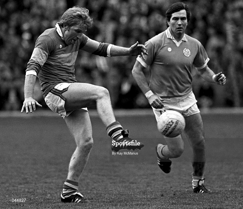 15 August 1982; Jimmy Deenihan of Kerry clears the ball despite the attentions of Joe Kernan of Armagh during the All-Ireland Football semi-final match between Kerry and Armagh at Croke Park, Dublin. Photo by Ray McManus/Sportsfile