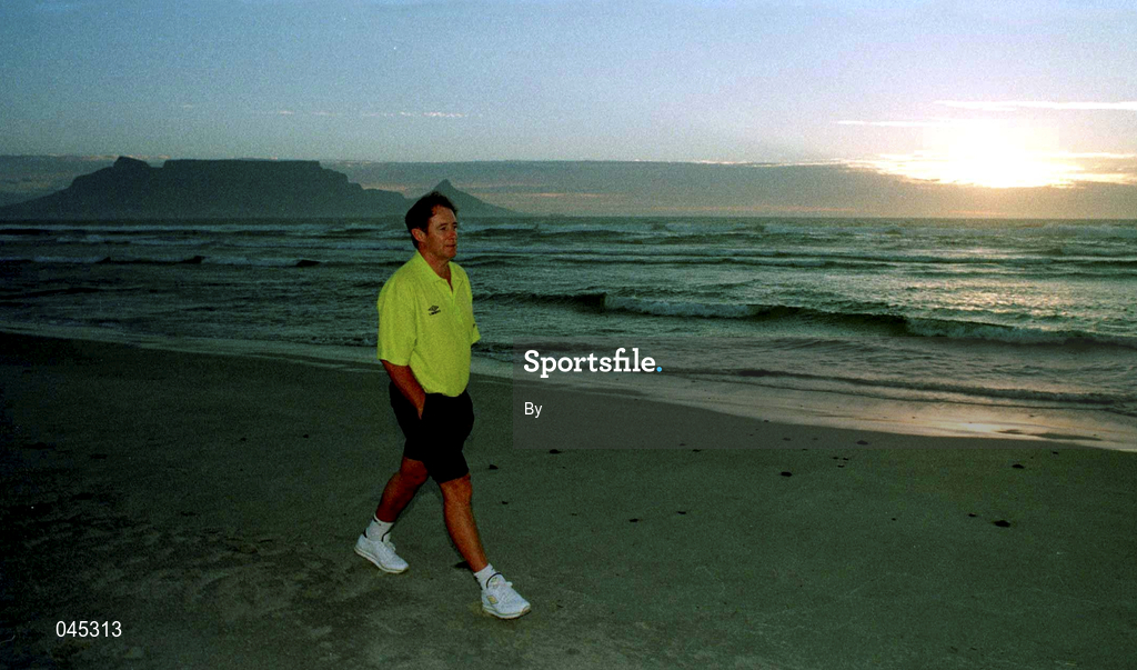 29 January 1999.  Rep of Irleland U.17 manager, Brian Kerr takes a walk on Dolphin beach, Capetown,South Africa with Tablemountain in the background before tormorrow's second game in  group A  against Spain in the Meridian tournament.  Soccer. Picture Credit: David Maher/SPORTSFILE.