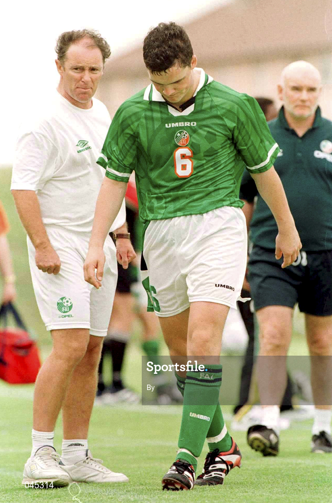 28 January 1999.  Republic of Ireland's Jim Goodwin, walks with his head down after being sent off as manager Brian Kerr watches on in the game against South Africa in Group A  of the U.17 Meridian Cup . The Athlone  stadium, Capetown, South Africa. Soccer. Picture Credit; David Maher/SPORTSFILE
