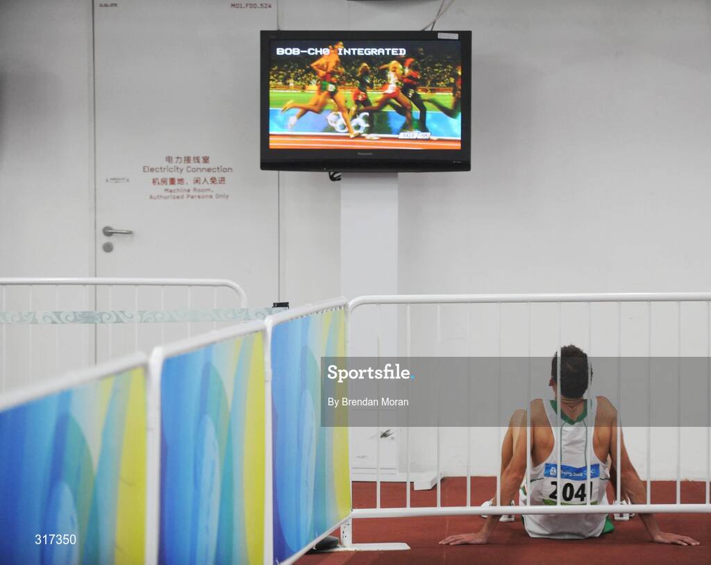 20 August 2008; Alistair Cragg, Ireland, sits watching the second heat of the Men's 5000m, after his heat where he finished 6th in a time of 13:38.57 and qualified for the final. Beijing 2008 - Games of the XXIX Olympiad, National Stadium, Olympic Green, Beijing, China. Picture credit: Brendan Moran / SPORTSFILE